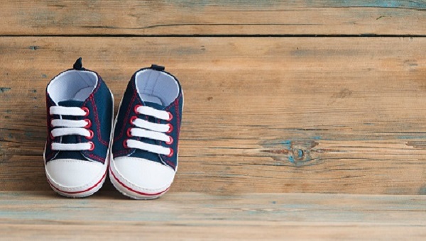 colorful shoes for a small baby on a wooden background