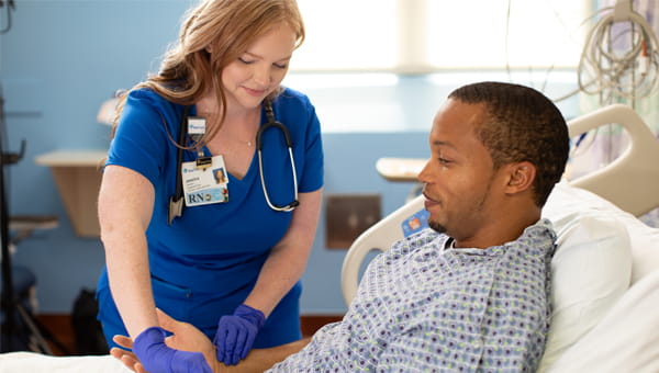 Female nurse caring for male patient