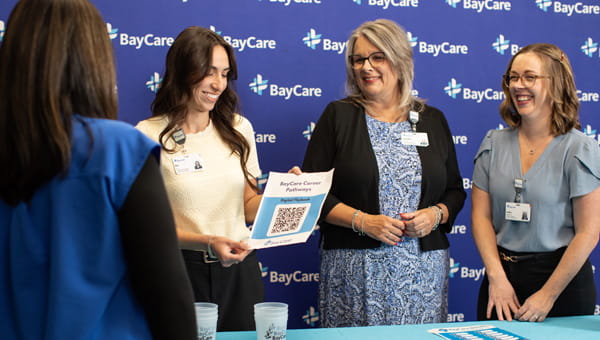 Four team members at a BayCare recruiting event.