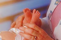 Picture of a nurse examining a newborn