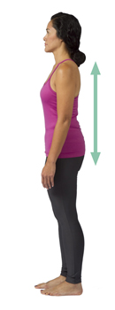 Side view of woman standing with ears, shoulders, hips, and ankles aligned.