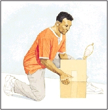 Image of man on one knee picking up a box