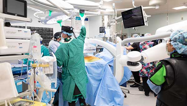 Surgeons wearing scrubs preparing for an operation