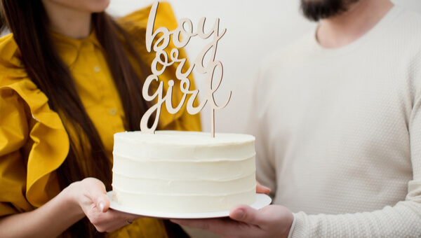 man and woman holding celebratory cake