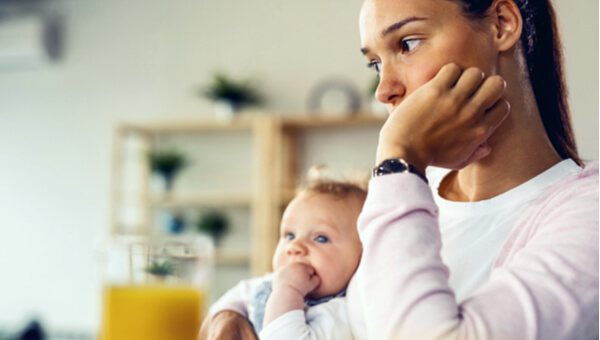 a woman and her newborn sitting down in thought