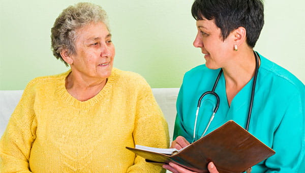 A doctor talking to a female patient about her family's medical history