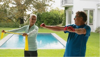 mature couple working out with resistance bands