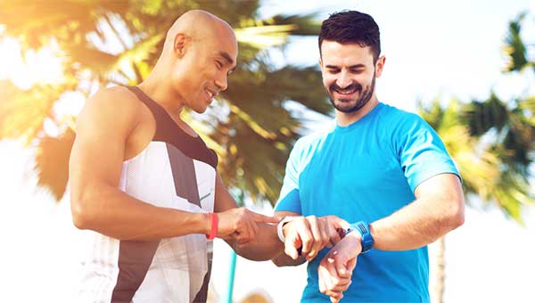 Learn more about taking your pulse & targeting heart rates two men exercising checking their heart monitors
