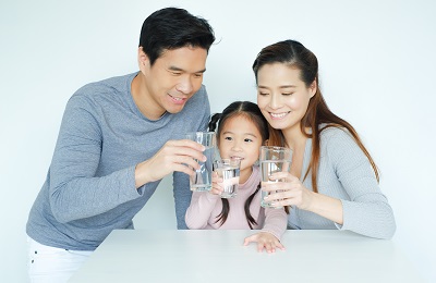 A family is drinking water together.