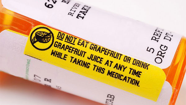 A prescription bottle with a label that warns the patient not to eat grapefruit or drink grapefruit juice while taking the medication.