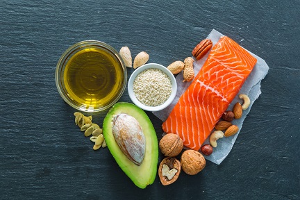 Collection of good fats like nuts, fish and avocado