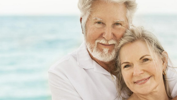 An older couple is spending time together at the beach.