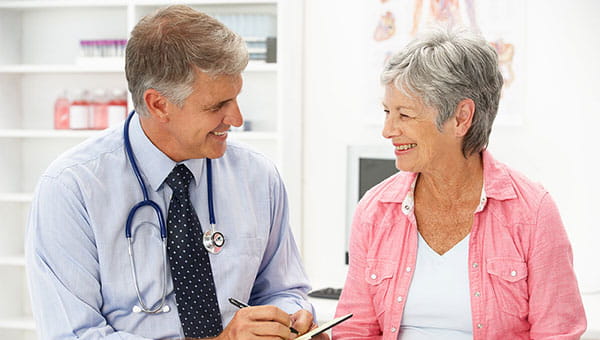 A senior woman is talking with her doctor.