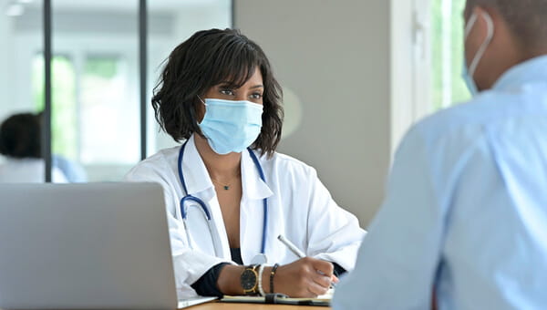 female doctor consulting with male patient