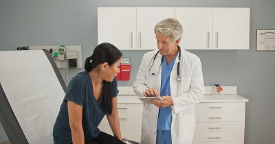 A female patient is talking with her doctor.