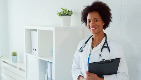 a doctor smiling with her clipboard