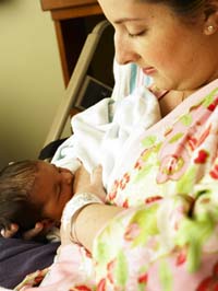 A mother is breastfeeding her newborn.