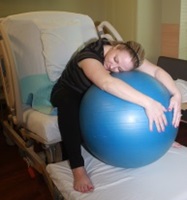 A woman demonstrating a maternity birthing position, option 3