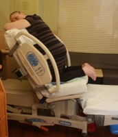 A woman demonstrating a maternity birthing position, option 6
