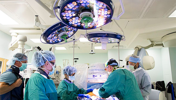 Surgical team performing surgery on a patient in an operating room