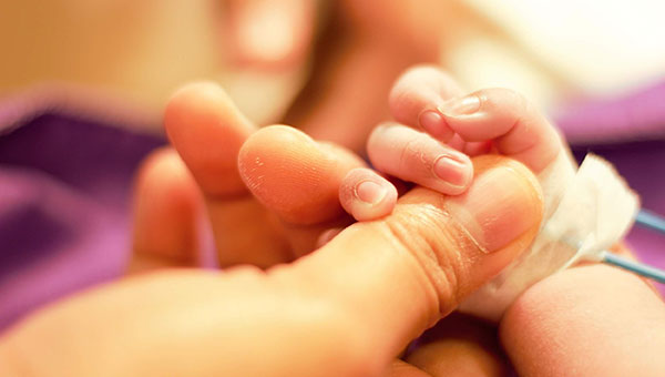 Holding tiny baby hand