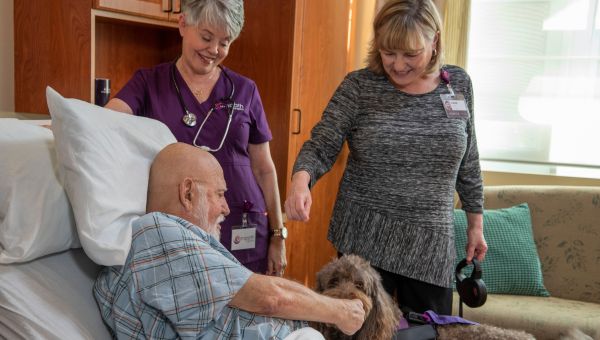 St. Joseph's Hospital Suncoast Hospice patient with a therapy dog.