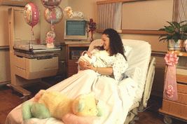 Mom holding her new baby in a delivery room