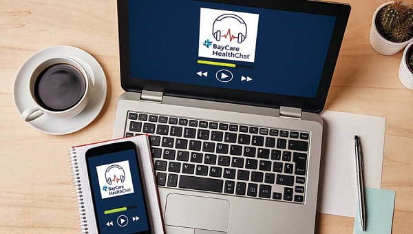 a laptop on a desk with the baycare healthchat podcast player open