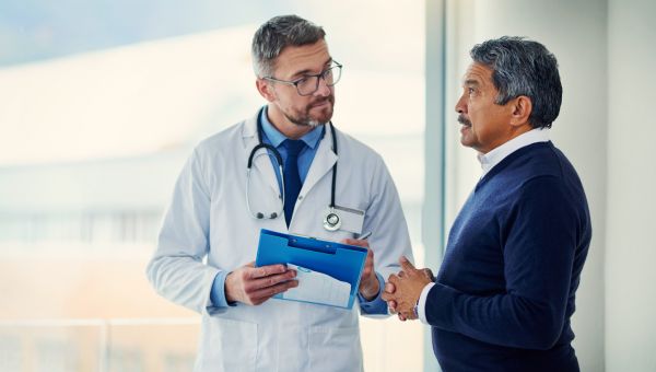 Male physician speaking to older patient