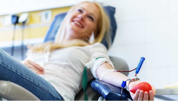 young female giving blood