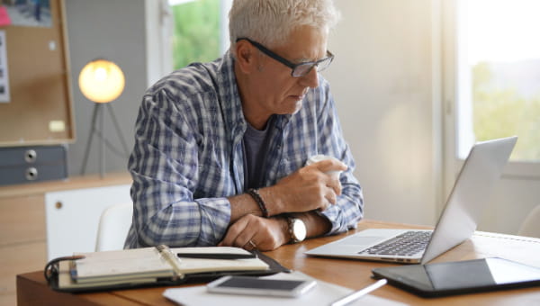 9 Things Every BayCarePlus Member Should Know Senior male doing research at home.