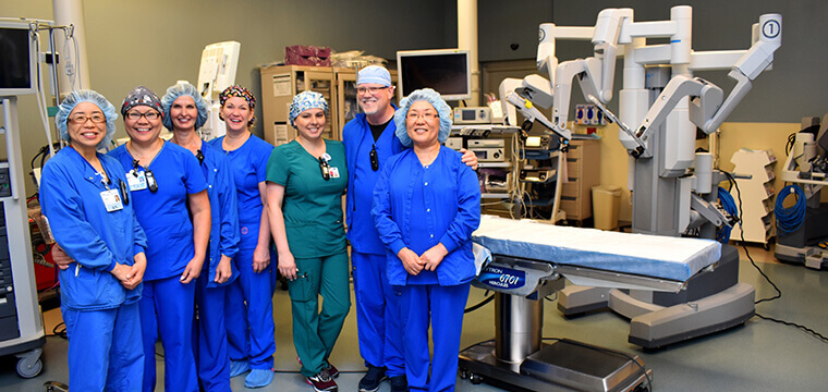 St. Joseph's Hospital-North robotic surgery team standing in front of the robot