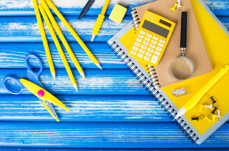 School supplies including scissors, pencils, a calculator and notebooks