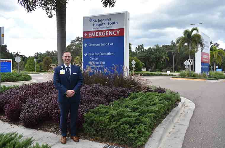 Dr. Christopher E. Bucciarelli in front of the St. Joseph's Hospital-South sign
