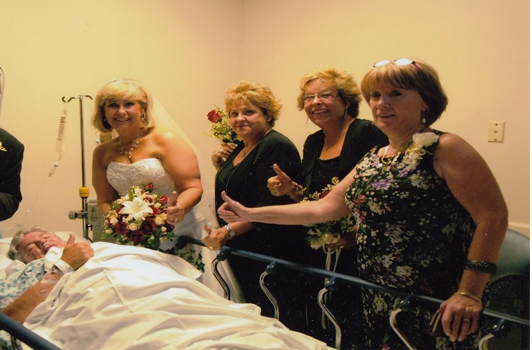 Dianna Vickers and her bridesmaids standing over Les in his emergency room bed.