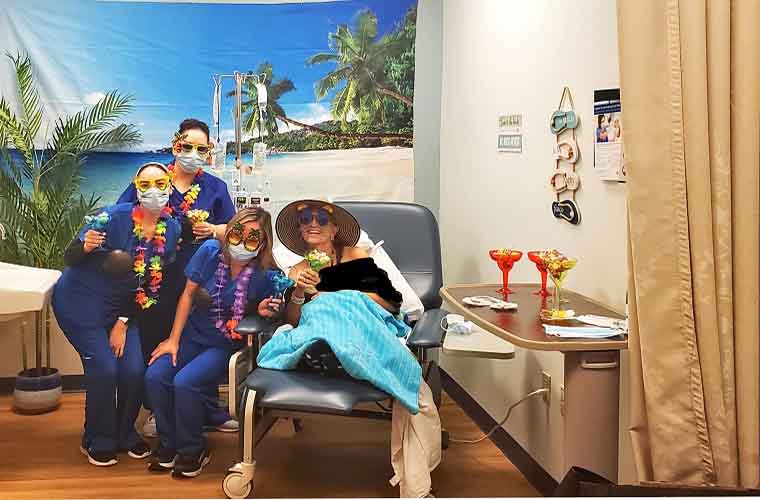 Mary Paul at the "Beach" infusion room with team members