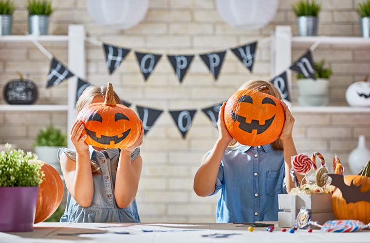 Children carving pumpkins for Halloween decorations. Halloween safety tips from BayCare Kids.