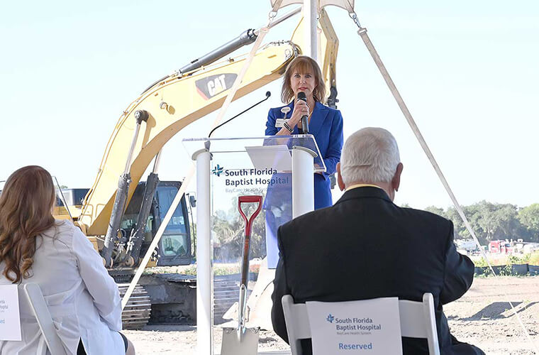 South Florida Baptist Hospital President Karen Kerr welcomes guests to the groundbreaking for the hospital's future location. 