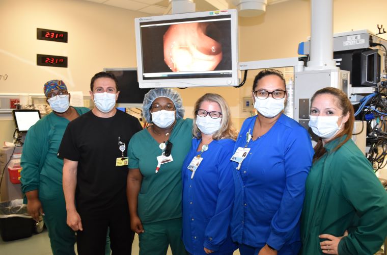 Some members of the St. Joseph's Hospital-North endoscopy team in front of the screen that the gastroenterologist sees.