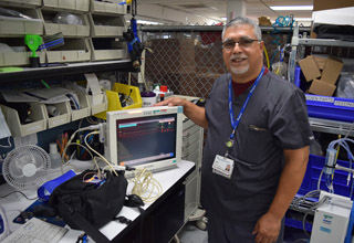 Elvin Velez stands in his work station at St. Joseph's Hospital, where he helps test, maintain and repair biomedical devices.