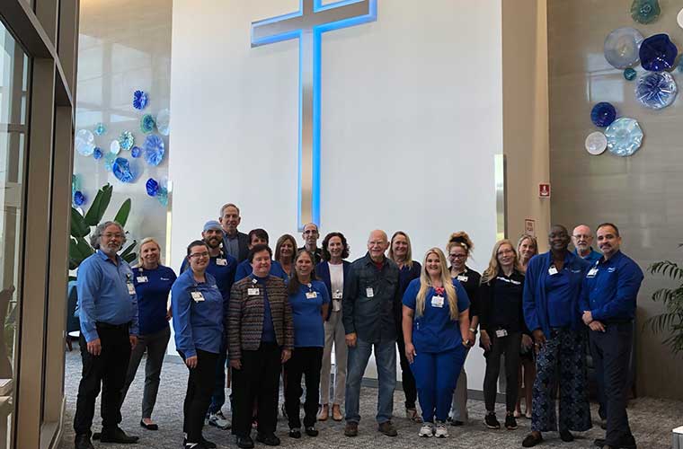 A large group of St. Anthony's Team Members wearing blue gather in the hospital lobby to show their support of Colorectal Cancer Awareness Month.