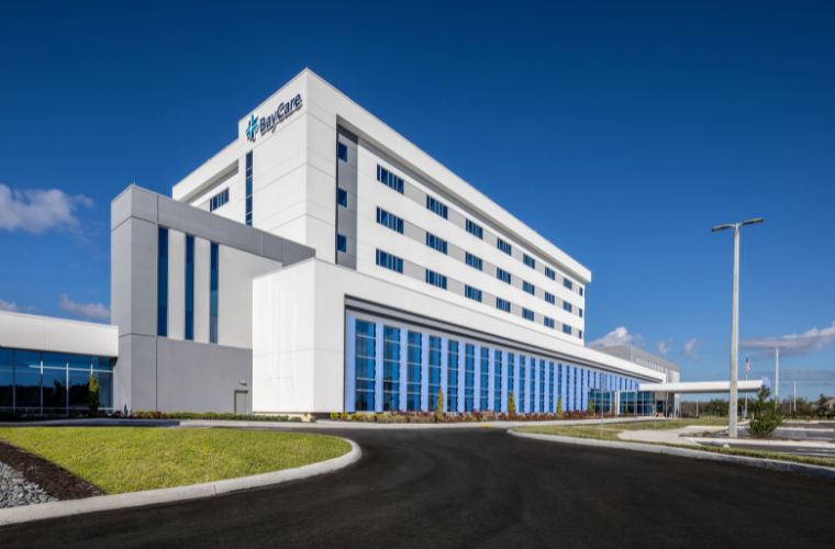Exterior view of the 86-bed BayCare Hospital Wesley Chapel showcases its bright, modern design painted white and featuring many windows for private patient rooms. 