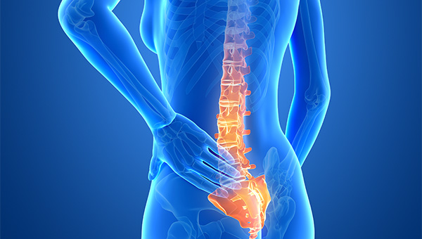 An illustration of a woman holding her lower back area because of pain.