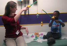 child life specialist working with a pediatric patient