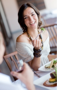 Woman eating salad at a restaurant