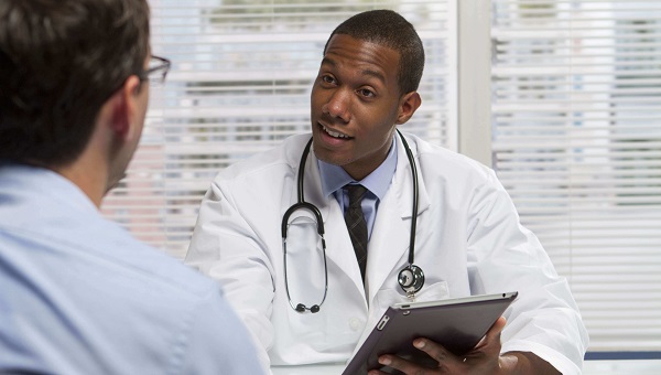 male physician speaking to a male patient