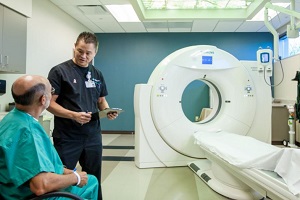 Tech preparing patient for a CT scan