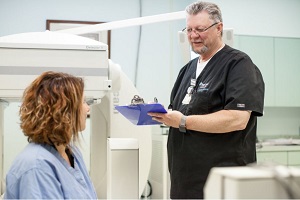 Tech preparing a patient for an imaging exam