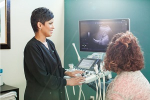 Tech and patient looking at ultrasound screen