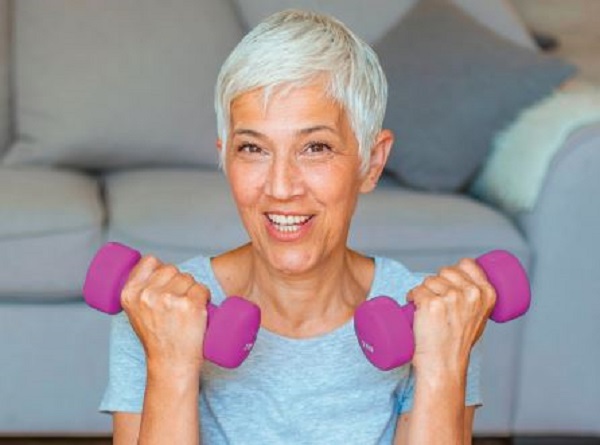 medical fitness program woman lifting pink dumbbells